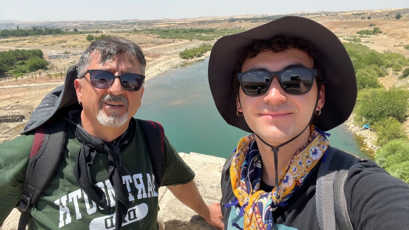 Dad's sporting Dartmouth gear on our hiking trip :) Blogger and his dad on top of a bridge with a river in the background.