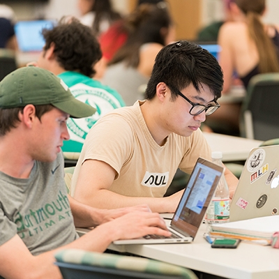 A photo of two students studying in a classroom