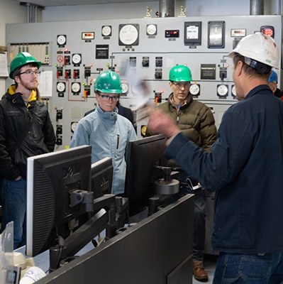 A photo of students touring the power plant faciliites