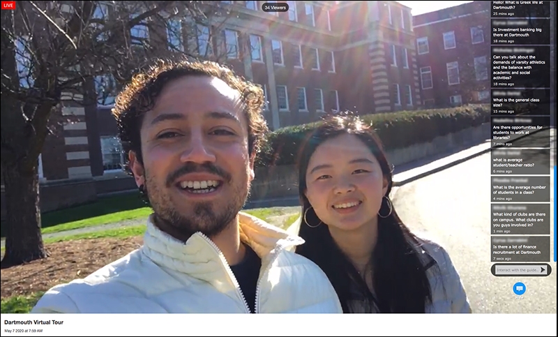 A photo of two tour guides giving a live, interactive tour of campus