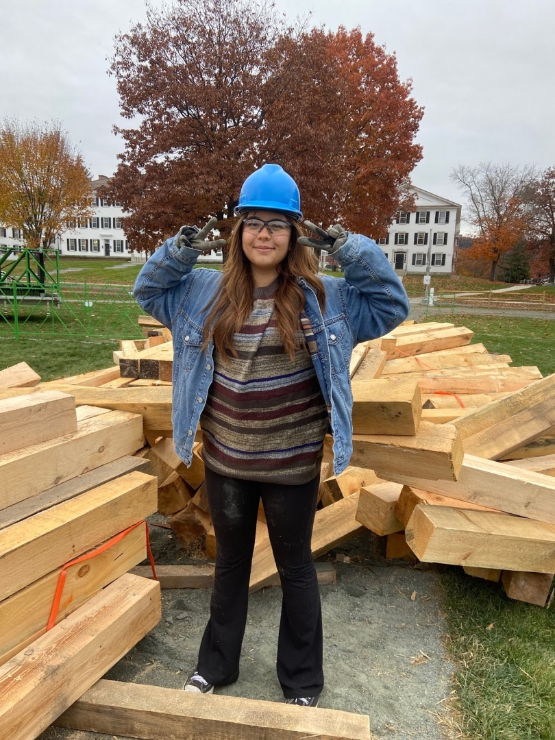 Photo of Alexa, a close friend of mine and amazing '28 posing in front of the pieces of wood that set up the foundation for the bonfire!