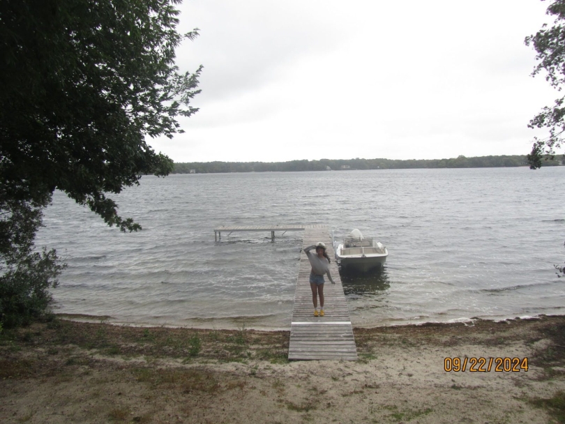 A girl standing on a boat dock.