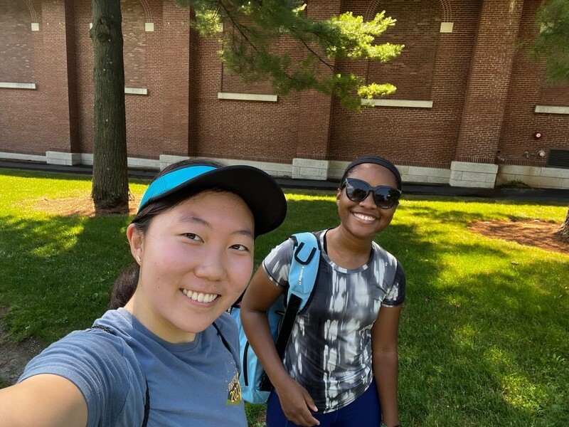 A selfie of blogger and friend in sunglasses walking outside in tennis gear
