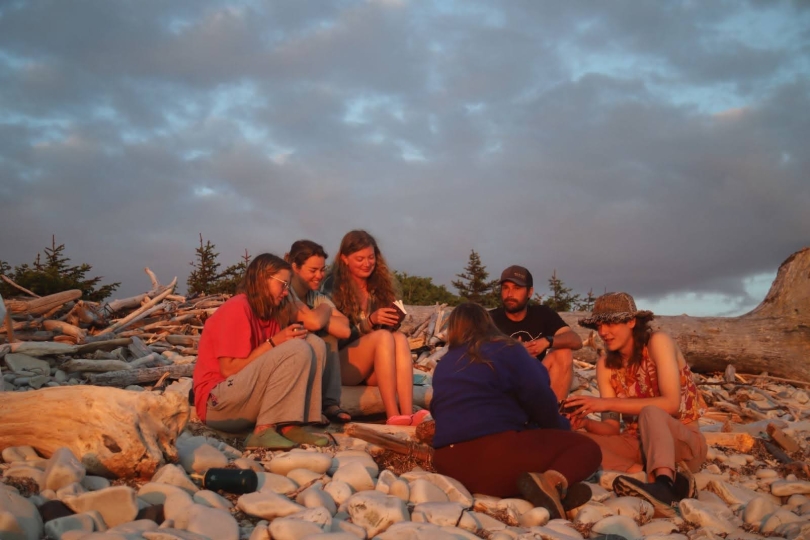 Some of my friends I made in Alaska playing card games on the beach during a beautiful sunset. 