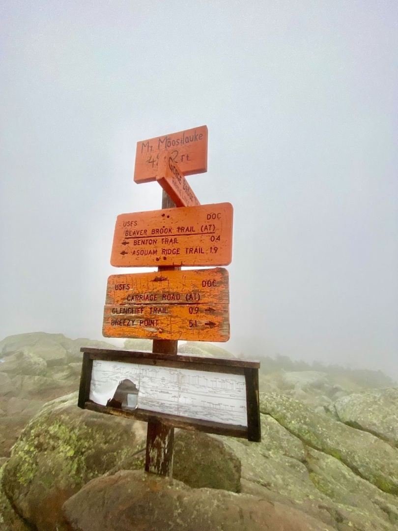  A stack of orange signs on the alpine summit of Mount Moosilauke. 