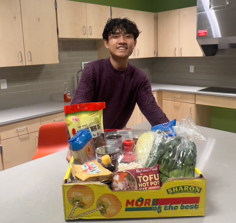 Tao smiling with ingredients to make hot pot