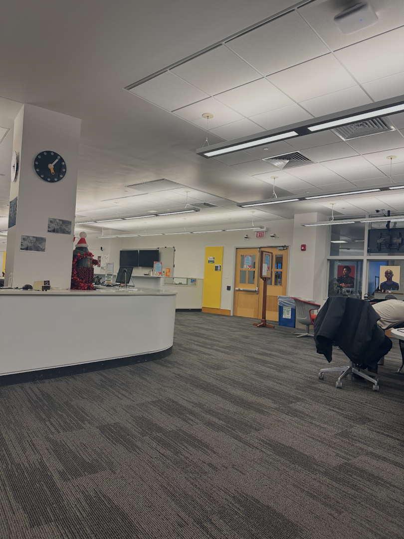 Library with a greeting desk and grey carpet.