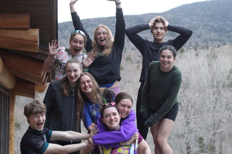 Dartmouth triathletes strike goofy poses at the Moosilauke Ravine Lodge. 