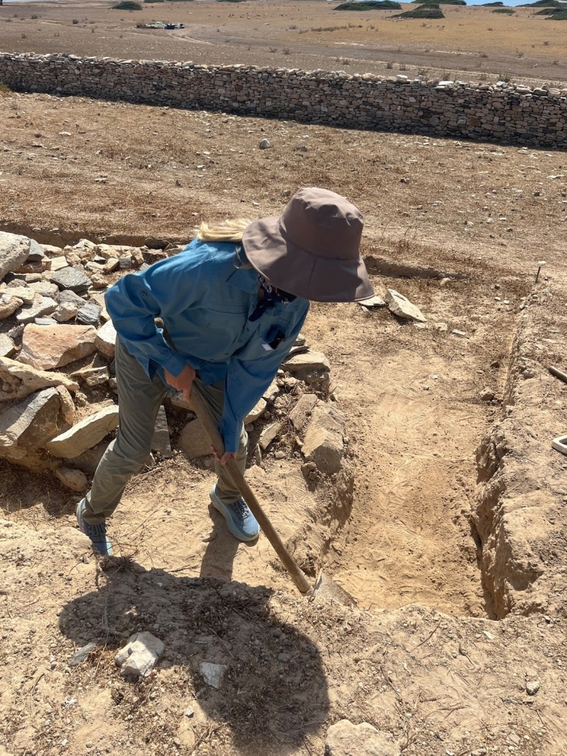 A woman shovels dirt
