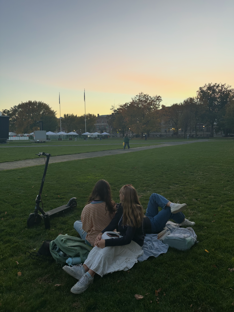 Picture of people lying on the grass looking at the sky.