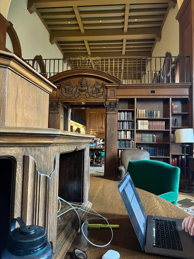 The Tower Room, with bookshelves, a laptop, and some oversized chairs.