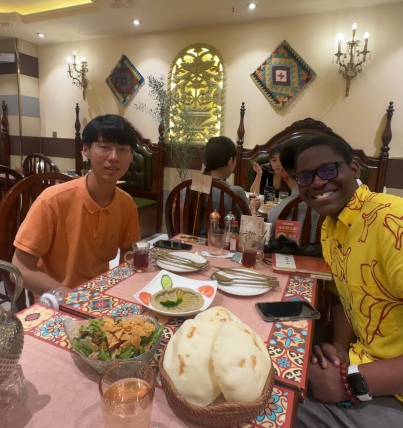 Photos of two boys smiling while at an Arabic restaurant