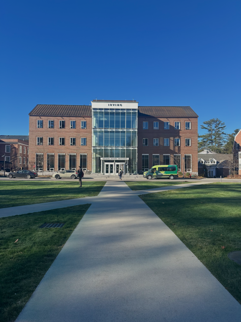 Picture of brick building with a glass section in the middle.