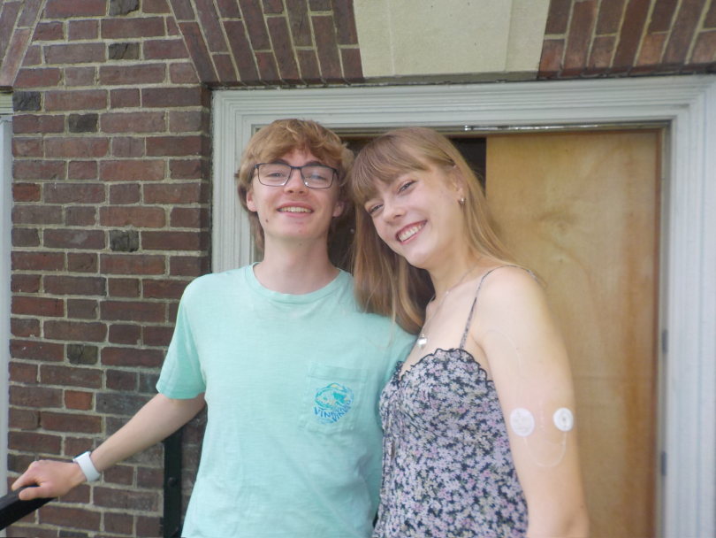 Two students smiling at the camera.