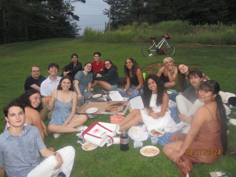 A large group of people having a picnic on the golf course