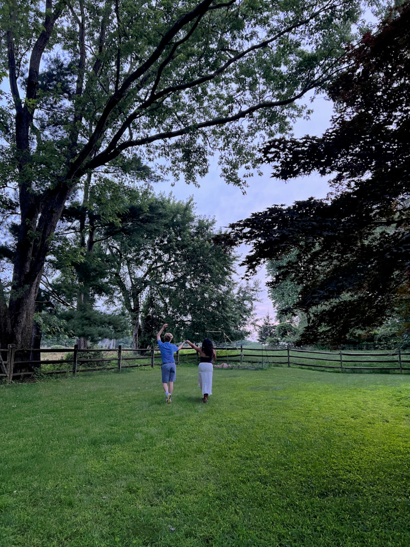 Picture of two people walking in a yard.
