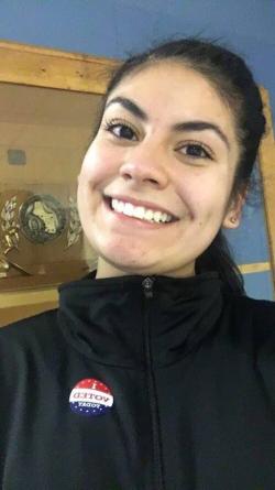 Girl posing with "I Voted!" sticker.