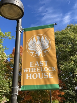 East Wheelock House Banner -- Orange with white text and a white phoenix