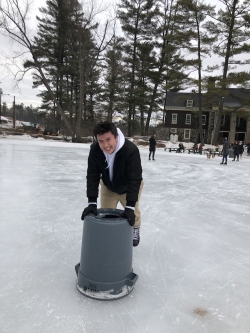 Gabe using a trash can to ice skate