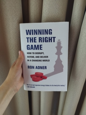 a picture of Professor Ron Adner's book Winning the Right Game against a beige curtain