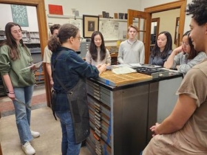 Photos show a group of students surrounding an instructor at the Dartmouth Book Arts Workshop