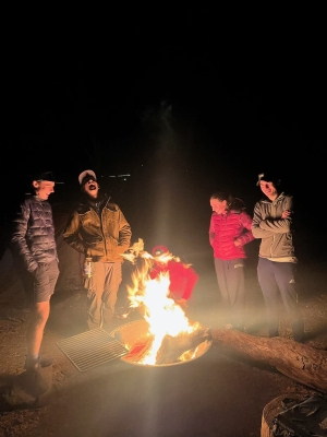 This is a picture from the mountain biking DOC trip to Sedona where the trip members were standing and sitting around a camp fire at night talking and laughing up a storm.