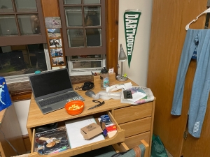 a picture of Kalina's messy desk and a Dartmouth banner on the wall behind it