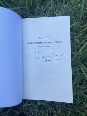 a picture of Abdul R. Latif's book propped open, so that his autograph and message to Kalina are visible