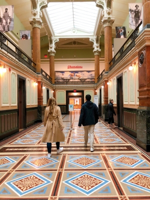 two friends walking through museum