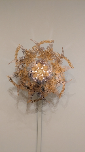 This is a work in the Attitude of Coexistence exhibit that moves and is supposed to emulate the sun.