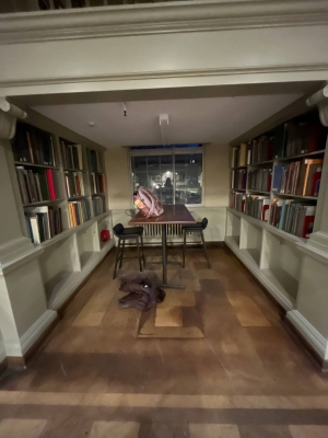 a picture of an enclosed library space with bookshelves.
