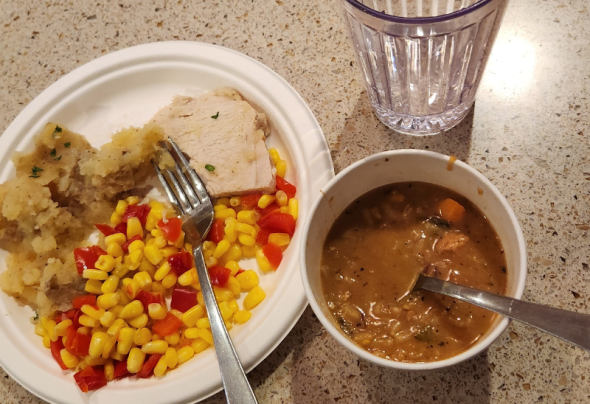 A picture of a plate of peppers, corn, and soup. 