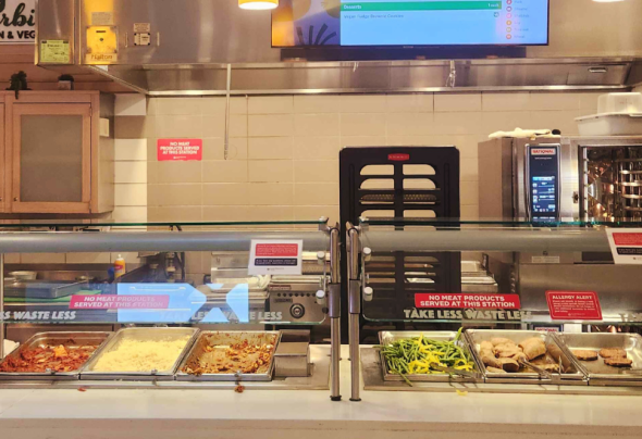 A photograph of a dining station with vegan and vegetarian food.