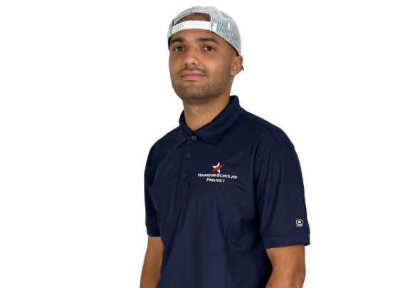 A photo of a man with a dark blue collared shirt and white hat, standing in a white background.
