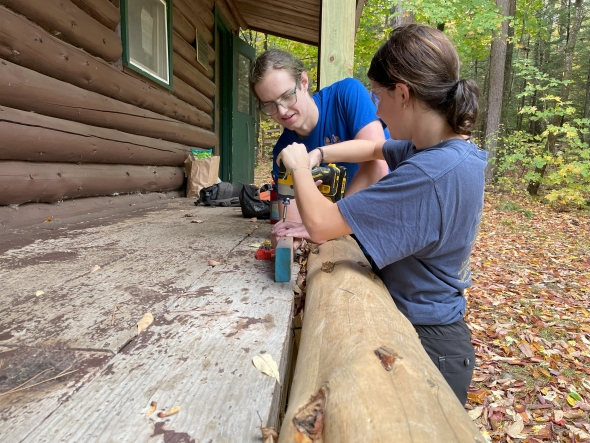 Isaac and Sydney are working on the cabin.