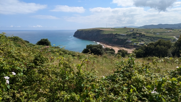 A view of the ocean and a beach from the Camino de Santiago.