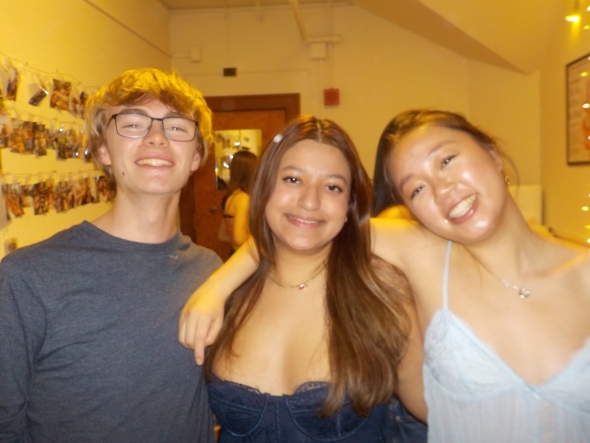 Picture of three students smiling at the camera. 