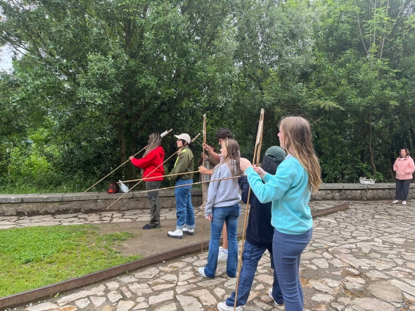 Atlatl practice, which is the prehistoric equivalent of a bow and arrow, outside the Cave of Castillo by throwing the thin spears into a thick foam block