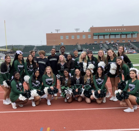My cheer team and I smiling during our first football game of the season.