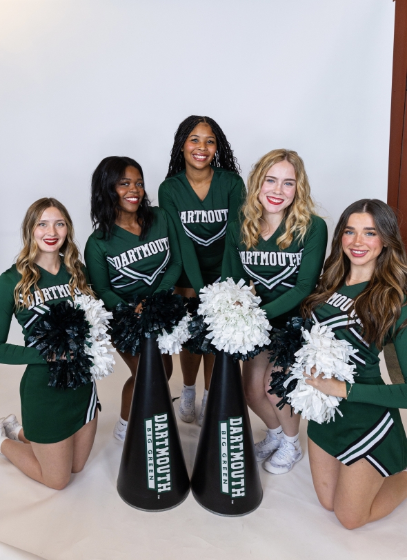 A group of cheerleaders smiling and posing together for a Media Day photo, radiating team spirit and excitement.