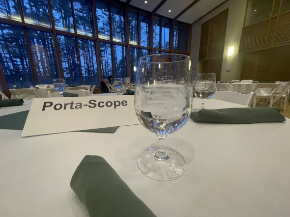 a picture of a tag saying Porta Scope on top of a table at a hall in Tuck School of Business