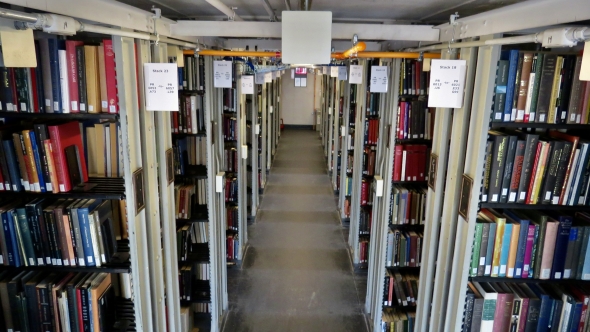 Centered view of an aisle of "The Stacks" in Baker-Berry Library.