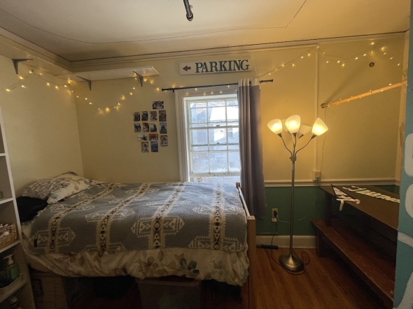 a picture of Kalina's bed under a sign saying Parking and a string of led lights
