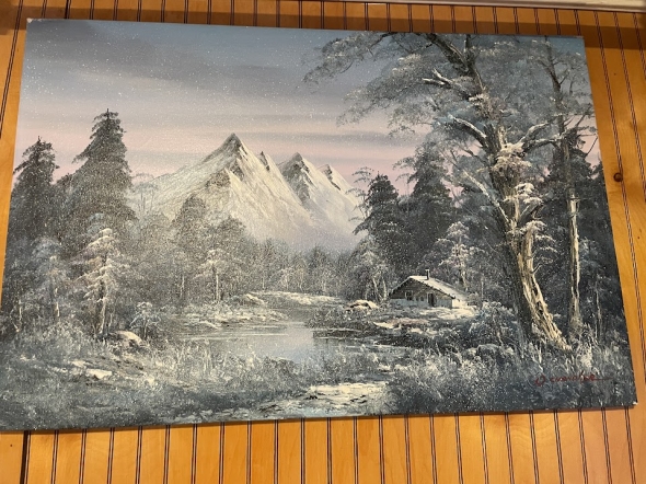  a picture of a painting of a snowy mountain against wooden background
