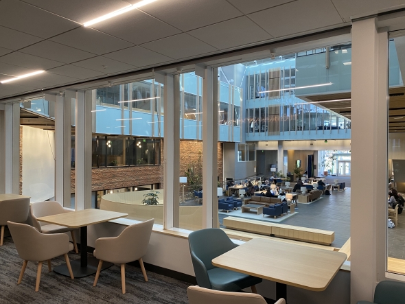 A rear view of the Irving Institute of Energy Atrium, a glass, metal, and wood lobby in the modern architectural style. 