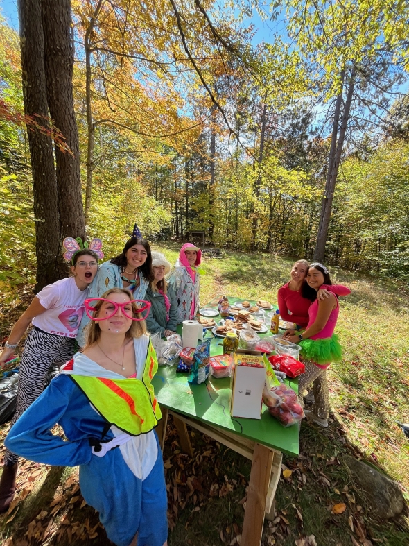 Dartmouth Students dressed in flair prepare food for Fifty hikers.