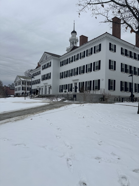 Picture of a white brick building with numerous windows.