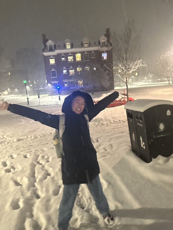 Student smiling in the snow.