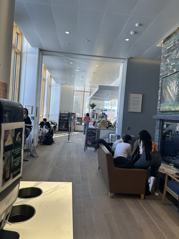 Picture of a cafe with people in line.