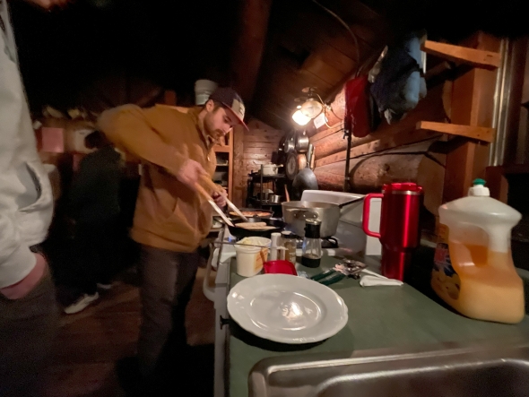 Jack is cooking in the dark cabin